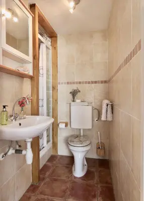 a bathroom with a toilet and a sink at Sea shell with balcony close to the beach, city centre and dunes in Zandvoort