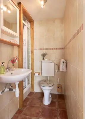 a bathroom with a toilet and a sink at Sea shell with balcony close to the beach, city centre and dunes in Zandvoort