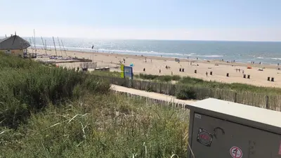 a view of a beach with people on it at Huis Zeeduin Amsterdam Beach in Zandvoort