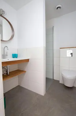 a white bathroom with a toilet and a sink at Huis Zeeduin Amsterdam Beach in Zandvoort