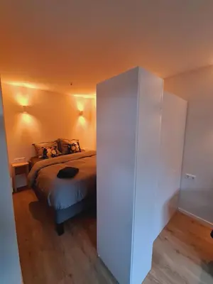 a bedroom with a bed and a white cabinet at Studio Baarn with patio, airco, pantry, bedroom, bathroom, privacy - Amsterdam, Utrecht in Baarn