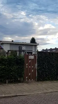 a building with a gate in front of a fence at Studio Baarn with patio, airco, pantry, bedroom, bathroom, privacy - Amsterdam, Utrecht in Baarn