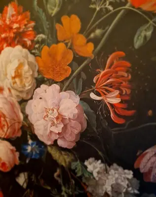a vase filled with flowers on a table at Studio Baarn with patio, airco, pantry, bedroom, bathroom, privacy - Amsterdam, Utrecht in Baarn