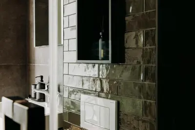a bathroom with a brick wall with a sink at Boutique B&B Oud Aa in Breukelen