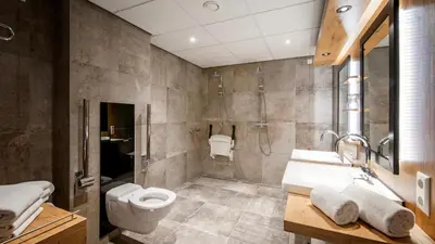 a bathroom with a toilet and a sink and a shower at De Egmonden in Egmond aan Zee