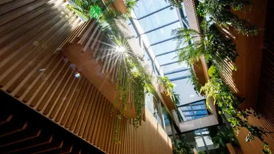a tall building with a bunch of plants in it at De Egmonden in Egmond aan Zee