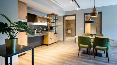 a kitchen and living room with a table and chairs at De Egmonden in Egmond aan Zee