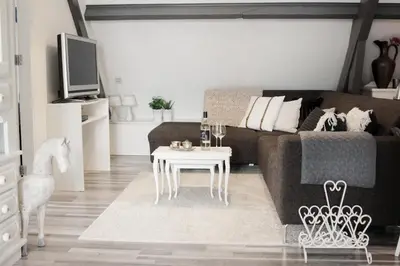 a living room with a couch and a table at Apartment Het Friesche Paard in Purmer