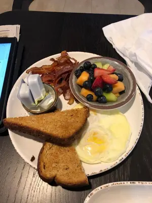 a plate of breakfast food with eggs and toast at 