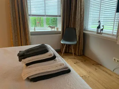 a bed with towels on it with a window at 