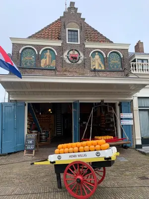 a cart full of oranges in front of a building at 