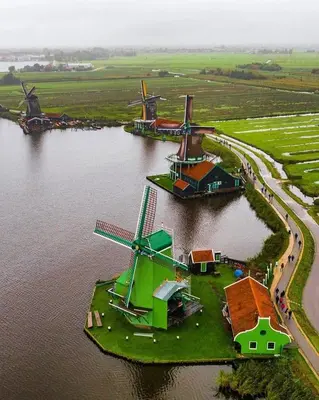 an island with three windmills in a body of water at 