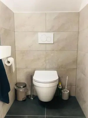 a bathroom with a white toilet in a room at Strand Villa Stern Noordwijk in Noordwijk