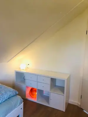 a bedroom with a white desk next to a bed at Strand Villa Stern Noordwijk in Noordwijk