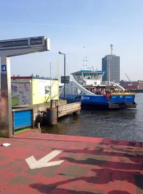 a large boat is docked at a dock in the water at B & B Tulp Amsterdam Noord in Amsterdam
