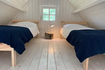 a bedroom with two beds in a attic at Bergen, Huisje dat ademt zee en vakantie... in Bergen