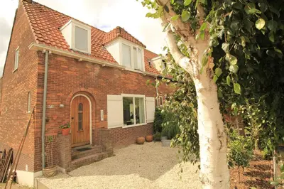 a brick house with a tree in front of it at House Akerdijk 5 persons 3 bedrooms in Badhoevedorp