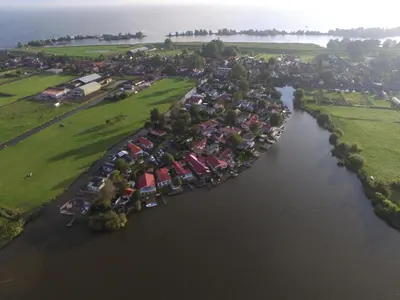 an aerial view of a river with houses at Ferienhaus mit wundervollem Seeblick Ferienpark Vislust Ijsselmeer in Wervershoof