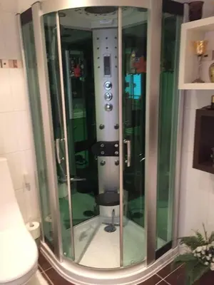 a glass shower in a bathroom with a toilet at Ferienhaus mit wundervollem Seeblick Ferienpark Vislust Ijsselmeer in Wervershoof