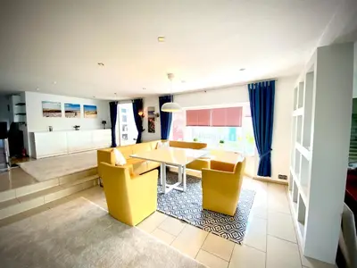 a living room with a yellow table and yellow chairs at Ferienhaus mit wundervollem Seeblick Ferienpark Vislust Ijsselmeer in Wervershoof