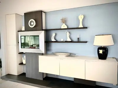a living room with white cabinets and shelves at Ferienhaus mit wundervollem Seeblick Ferienpark Vislust Ijsselmeer in Wervershoof