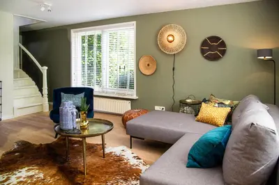 a living room with a couch and a table at Gastenverblijf KortVertoef in Kortenhoef