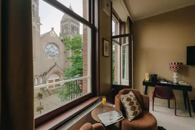 a room with a window with a view of a church at Hotel Omega in Amsterdam