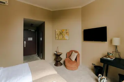 a hotel room with a bed and a chair at Hotel Omega in Amsterdam