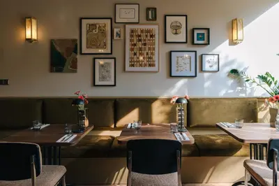 a restaurant with two tables and a couch at Hotel Omega in Amsterdam