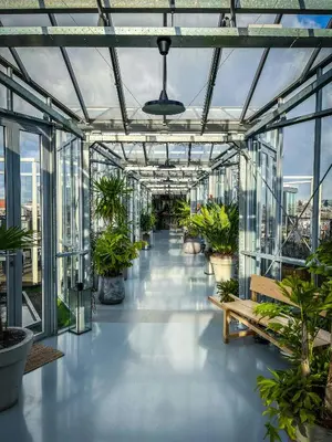 a glass greenhouse with potted plants in it at Trendy 2 bedroom accommodation on perfect location in Amsterdam