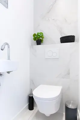 a white bathroom with a toilet and a sink at Trendy 2 bedroom accommodation on perfect location in Amsterdam