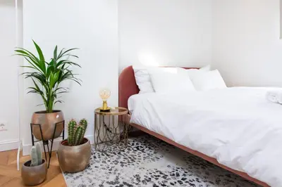 a bedroom with a white bed and potted plants at Trendy 2 bedroom accommodation on perfect location in Amsterdam