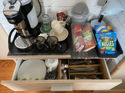 a kitchen counter top with a coffee maker on it at Tinyhouse Woody at the Water in Zaandam