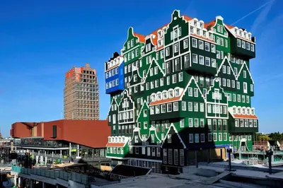 a tall building with a green and white at Tinyhouse Woody at the Water in Zaandam