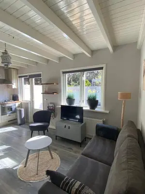a living room with a couch and a table at Vakantiewoning Van der Meer, Egmond aan Zee in Egmond aan Zee