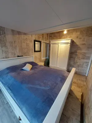 a large bedroom with a large bed in it at Cottage 322 in Dirkshorn