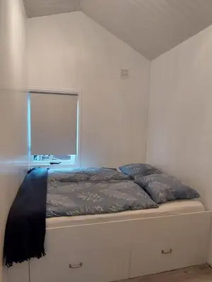 a bed in a room with a window at Cottage 322 in Dirkshorn