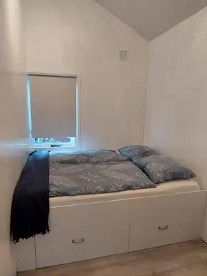 a bed in a room with a window at Cottage 322 in Dirkshorn