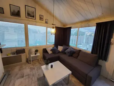 a living room with a couch and a table at Cottage 322 in Dirkshorn
