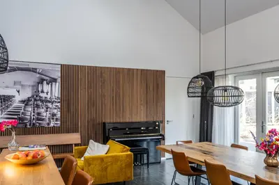 a dining room with a table and a fireplace at Bed & Breakfast De Oude Kapel in Driebergen
