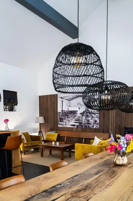 a dining room with a table and chairs at Bed & Breakfast De Oude Kapel in Driebergen