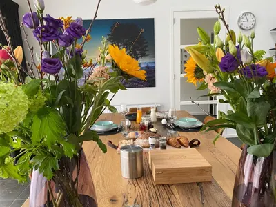 a table with vases filled with flowers on it at Bed & Breakfast De Oude Kapel in Driebergen