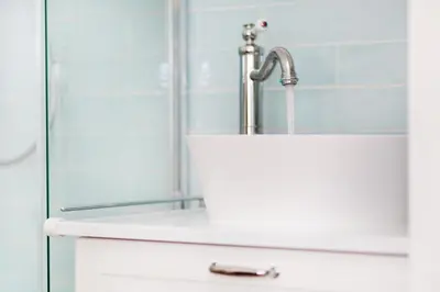 a bathroom with a sink and a faucet at Bed & Breakfast De Oude Kapel in Driebergen