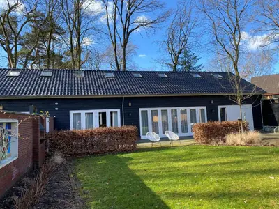 a blue house with a yard in front of it at Bed & Breakfast De Oude Kapel in Driebergen