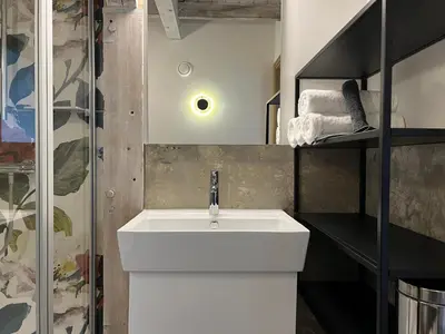 a bathroom with a white sink and a shower at Pakasa in Leiden