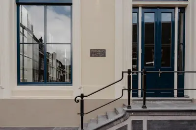 a building with a blue door and stairs in front at The Nox Hotel in Utrecht