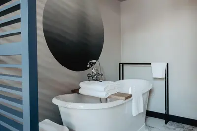 a bathroom with a bath tub and a sink at The Nox Hotel in Utrecht