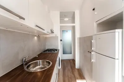 a kitchen with a sink and a refrigerator at Green Happiness With Private Parking in Zandvoort