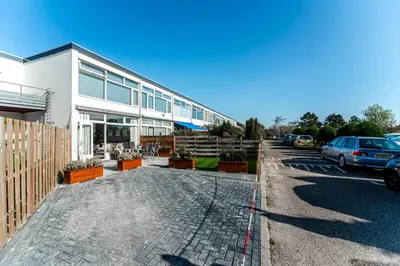 a car parked in front of a building at Green Happiness With Private Parking in Zandvoort