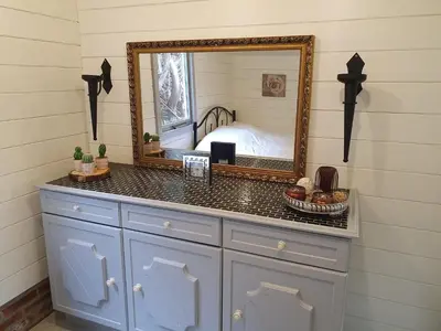 a bathroom with a vanity with a mirror on it at het Uylennest, uniek en goedkoop! in Hem
